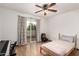 Bedroom with wood flooring, ceiling fan, sliding glass doors, and music accessories at 4721 W Eva St, Glendale, AZ 85302