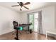 Bedroom featuring wood flooring, ceiling fan, and a black desk at 4721 W Eva St, Glendale, AZ 85302