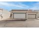 A view of the home's exterior featuring a white exterior, garage doors, and unit numbers at 4721 W Eva St, Glendale, AZ 85302