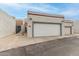 A view of the home's exterior featuring a white exterior, garage doors, and unit numbers at 4721 W Eva St, Glendale, AZ 85302