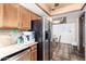 Kitchen with stainless steel refrigerator, Saltillo tile, and wood cabinets at 4721 W Eva St, Glendale, AZ 85302