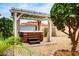 Relaxing hot tub retreat with wooden accents and a pergola, nestled in a private backyard setting at 5217 E Tunder Cir, Phoenix, AZ 85044