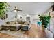 Open-concept living room flows into the kitchen, featuring hardwood floors and stylish furnishings at 5217 E Tunder Cir, Phoenix, AZ 85044