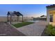 An exquisite pool is surrounded by pavers and two gazebos with decorative outdoor string lights at 5245 N 205Th Ln, Buckeye, AZ 85396