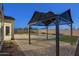 Backyard pool with a gazebo, string lights, artificial grass, and brick paver decking at 5245 N 205Th Ln, Buckeye, AZ 85396