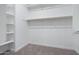 A spacious walk-in closet with built-in shelving and hanging rods provides ample storage at 5245 N 205Th Ln, Buckeye, AZ 85396