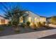 Charming single-story home with a well-manicured front yard and an attached two-car garage at 5245 N 205Th Ln, Buckeye, AZ 85396