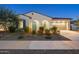 Beautiful single-story home with desert landscaping, arched entry, and a convenient two-car garage at 5245 N 205Th Ln, Buckeye, AZ 85396