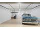 A clean, organized garage with epoxy flooring and ample storage space for vehicles and equipment at 5245 N 205Th Ln, Buckeye, AZ 85396