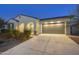 Exterior of house with wide driveway leading to a two car garage, with desert landscaping at 5245 N 205Th Ln, Buckeye, AZ 85396