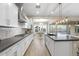 Modern kitchen with a view to the dining area, stainless steel appliances, and a center island with pendant lighting at 5245 N 205Th Ln, Buckeye, AZ 85396