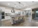 Kitchen featuring a gray island, white cabinets, stainless appliances, and wood floors at 5245 N 205Th Ln, Buckeye, AZ 85396