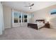 Bedroom with large windows, carpet, and ceiling fan at 5245 N 205Th Ln, Buckeye, AZ 85396