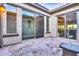 Travertine tile patio with stucco walls, outdoor lighting, and multiple sliding glass doors for indoor/outdoor living at 5245 N 205Th Ln, Buckeye, AZ 85396