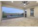 Large covered patio with ceiling fan provides view of pool, pergola and string lights in backyard at 5245 N 205Th Ln, Buckeye, AZ 85396