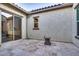 Covered patio with travertine tile flooring, neutral stucco walls, and sliding glass doors at 5245 N 205Th Ln, Buckeye, AZ 85396