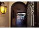 Covered carport view through decorative front door featuring elegant ironwork and glass panel at 5301 W Vernon Ave, Phoenix, AZ 85035