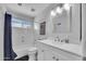 Bathroom featuring a white vanity, tub, and shower at 5611 W Blackhawk Dr, Glendale, AZ 85308