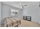 Cozy bedroom featuring natural light, neutral tones and a ceiling fan at 5611 W Blackhawk Dr, Glendale, AZ 85308