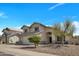 Charming two-story home with a well-maintained front yard and attached two car garage at 5611 W Blackhawk Dr, Glendale, AZ 85308