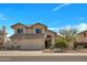 Charming two-story home with a well-maintained front yard and attached two car garage at 5611 W Blackhawk Dr, Glendale, AZ 85308