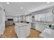 Open kitchen flows into the living area, featuring a large island and stainless steel appliances for modern living at 5611 W Blackhawk Dr, Glendale, AZ 85308