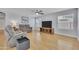 Comfortable living room with laminate floors, ceiling fan, and natural light, perfect for relaxation and entertainment at 5611 W Blackhawk Dr, Glendale, AZ 85308