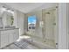 Bright main bathroom featuring double vanity, granite countertop and a glass-enclosed shower at 5611 W Blackhawk Dr, Glendale, AZ 85308