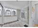 Bright main bathroom featuring double vanity, tile floors, and a glass-enclosed shower at 5611 W Blackhawk Dr, Glendale, AZ 85308