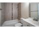 A newly renovated bathroom featuring modern fixtures, stylish tiling, and a clean white vanity at 5638 N 61St Ln, Glendale, AZ 85301