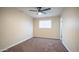 A bright bedroom featuring brick walls, ceiling fan, neutral carpet, and natural light at 5638 N 61St Ln, Glendale, AZ 85301