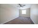 Bedroom featuring neutral carpet, a ceiling fan, and natural light from a window at 5638 N 61St Ln, Glendale, AZ 85301