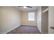 A cozy bedroom with neutral-colored walls, carpeted floors, and a modern ceiling fan fixture at 5638 N 61St Ln, Glendale, AZ 85301