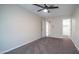 A spacious bedroom features neutral colors, carpet, and a door leading to a walk-in closet at 5638 N 61St Ln, Glendale, AZ 85301