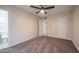 A cozy bedroom featuring neutral colors, carpet, and a door leading to a bathroom at 5638 N 61St Ln, Glendale, AZ 85301