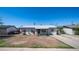 Charming single-story home with well-maintained landscaping, blue sky, and a long driveway at 5638 N 61St Ln, Glendale, AZ 85301