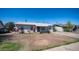 Cozy single-story house featuring a well-manicured lawn, blooming plants, and a paved driveway at 5638 N 61St Ln, Glendale, AZ 85301