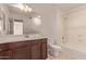 Bathroom featuring dark wood vanity, sink, and tub/shower combination at 6755 S Tucana Ln, Gilbert, AZ 85298