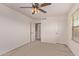 Neutral bedroom with ceiling fan, closet and access to an en suite bathroom at 6755 S Tucana Ln, Gilbert, AZ 85298