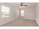 Bright bedroom features a ceiling fan and multiple windows for natural light at 6755 S Tucana Ln, Gilbert, AZ 85298