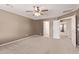 Spacious bedroom featuring a ceiling fan and neutral carpeting at 6755 S Tucana Ln, Gilbert, AZ 85298