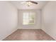 Bright, vacant bedroom with tile floors, ceiling fan, and window at 6755 S Tucana Ln, Gilbert, AZ 85298