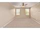 Spacious bedroom with neutral carpet, ceiling fan and two windows at 6755 S Tucana Ln, Gilbert, AZ 85298