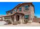 Inviting two-story home featuring desert landscaping, a three-car garage and a covered entry at 6755 S Tucana Ln, Gilbert, AZ 85298