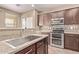 Modern kitchen featuring stainless steel appliances, tile backsplash, and granite countertops at 6755 S Tucana Ln, Gilbert, AZ 85298