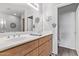 Bathroom with double sinks, wood cabinets, decorative wall hangings, and gray walls at 705 W Queen Creek Rd # 1154, Chandler, AZ 85248