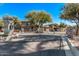 Gated community entrance with lush landscaping and mature trees at 705 W Queen Creek Rd # 1154, Chandler, AZ 85248