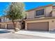 Desert townhome with two-car garage, neutral stucco, and desert landscaping at 705 W Queen Creek Rd # 1154, Chandler, AZ 85248