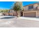 Desert townhome with multi-car garages, neutral stucco, and desert landscaping at 705 W Queen Creek Rd # 1154, Chandler, AZ 85248