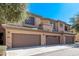 Desert townhome with two-car garage, neutral stucco, and desert landscaping at 705 W Queen Creek Rd # 1154, Chandler, AZ 85248